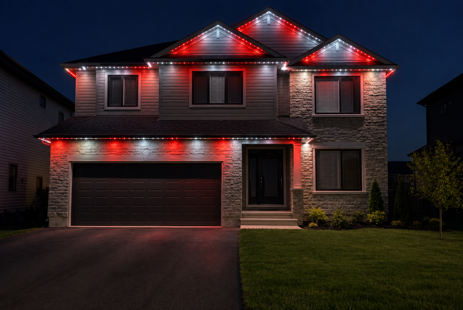 The same Ottawa home at night with canada day permanent track lighting