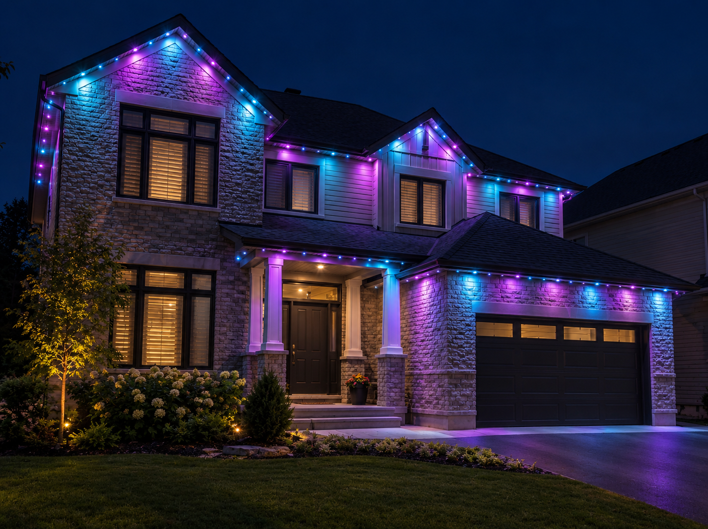 Two-story Ottawa stone home with permanent purple and blue track lighting along the rooflines